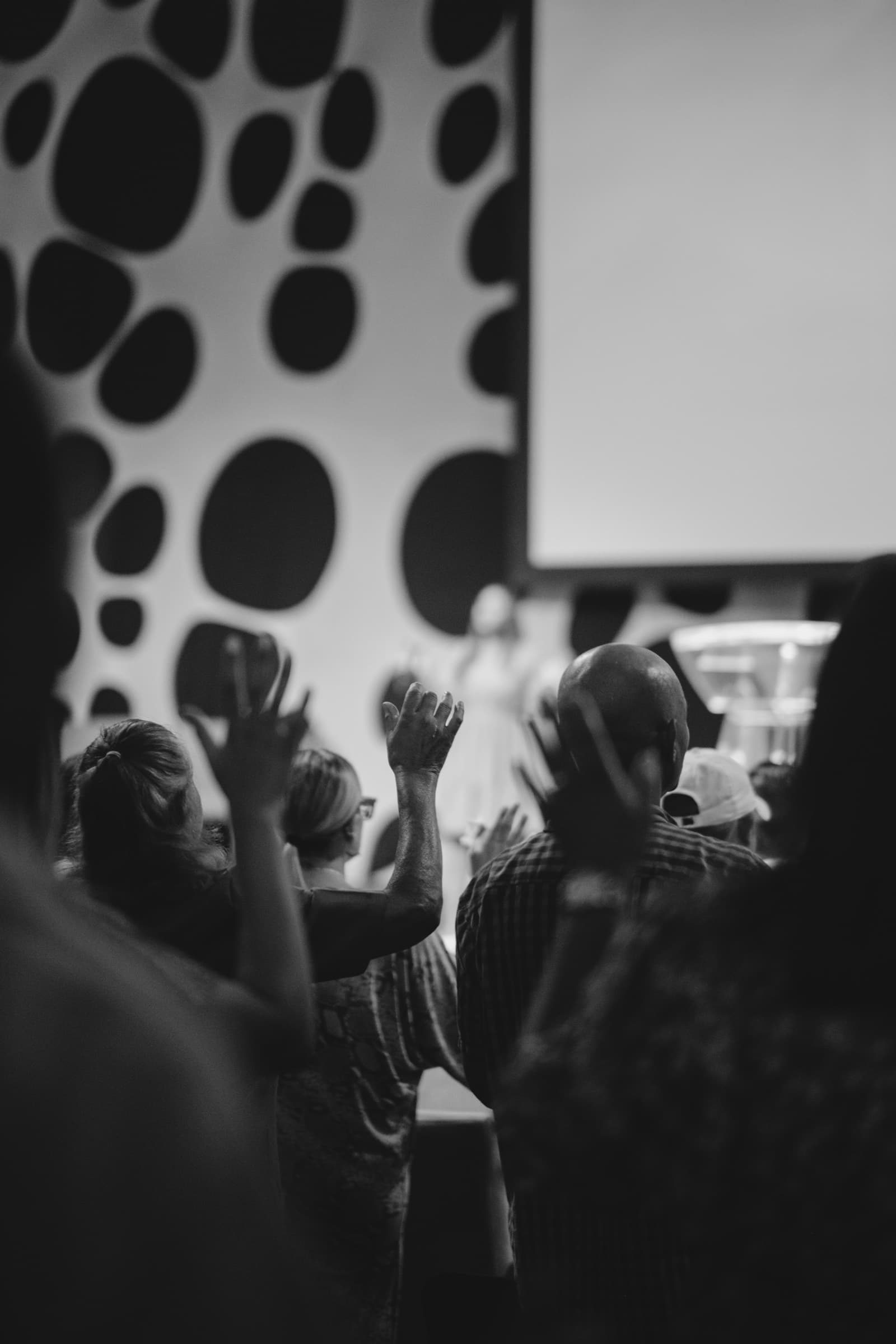 A worshipper with hands raised during a Sunday service